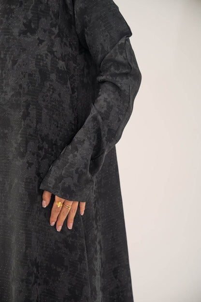 Black silk open-front abaya with subtle abstract woven pattern and light shimmer in charcoal gray finish