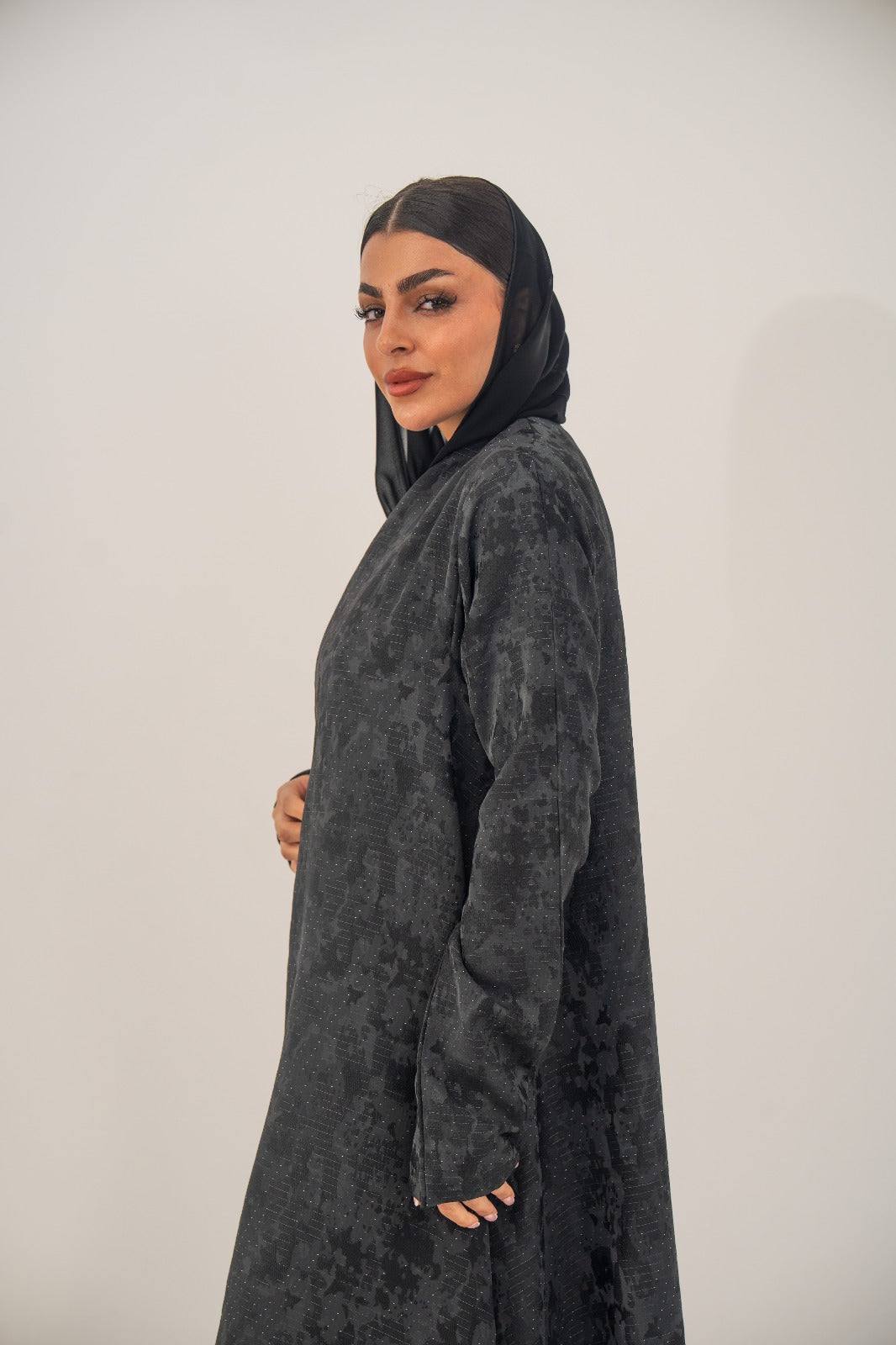 Black silk open-front abaya with subtle abstract woven pattern and light shimmer in charcoal gray finish